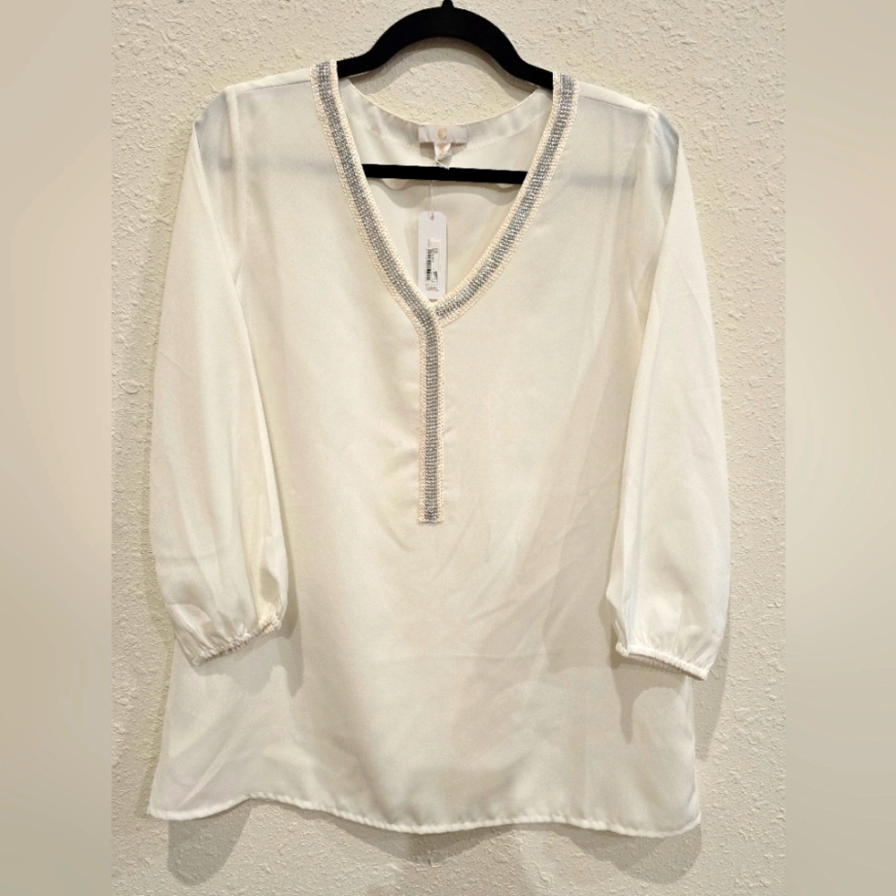 Ladies Silky Ivory-white shirt with silver seraquins.